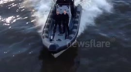 Daniel Craig as James Bond speeds past MI6 on River Thames in London