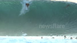 Surfers tackle huge waves during high surf warning along O'ahu's North Shore, Hawaii