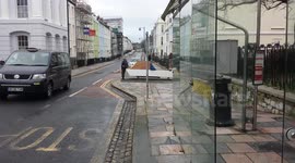 homless man attempting to take.make shift boat out to sea