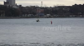 Santa Claus paddle boards the Niagara River, Canada