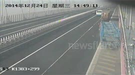 Truck nearly flies off bridge in China