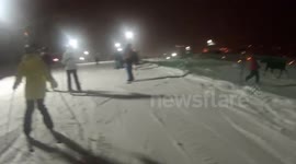 Moose charges skiers