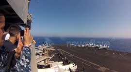 Watch fighter jet break sound barrier while flying past US aircraft carrier