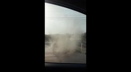 Driver comes face-to-face with a dust tornado