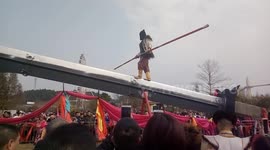 Kung fu master walks and does balance tricks on giant knife-edge