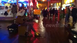 Chinese New Year 2019 in London Chinatown - musician Henry Facey entertains crowds singing Michelle Ma Belle