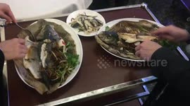 Restaurant staffs taking of the bone of the fish