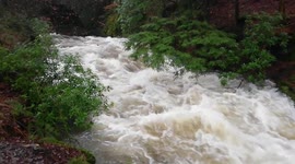 Heavy rain from Storm Erik turns Lake District rivers into raging torrents at Rydal Hall, Ambleside, UK