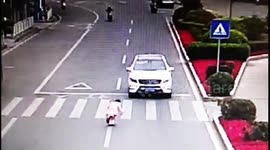 Polite girl bows to car driver after he stops to let her cross the road
