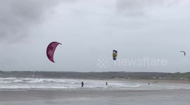 Kite surfers make most of gale-force winds in Cornwall, UK