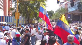 Venezuelans walk to a meeting point to support Juan Guaido