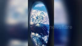 Creative man uses washing liquid bottle and phone to fake travelling on plane