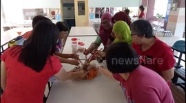 Chinese and Muslims Tossing Yee Sang together During Chinese New Year in Malaysia