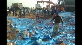 Land of colour? Truck in India carrying paint flips, causing rush of looting