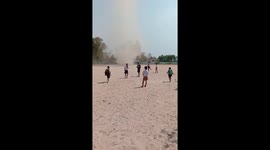 Children flee as mini tornado whips through school field in Thailand