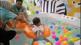 These floating babies relax at baby spa like a boss