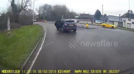 UK driver swings around a roundabout with back door open