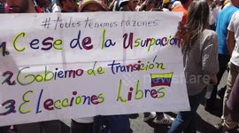 Women holding sign in march against Maduro