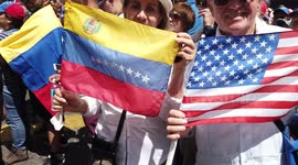 Man holds American flag in Venezuelan march