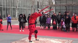 Performers impress visitors by somersaulting on stilts at Chinese temple fair