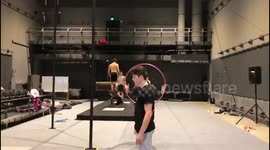 French circus artist lands crazy backwards somersault through tiny hoop