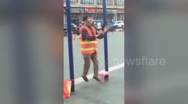 Old Chinese woman suspends her head from horizontal bar to work out