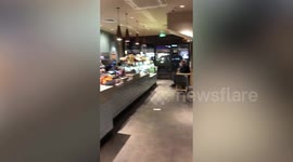 Moment brave barista takes on man with CHAIN after allegedly locking himself in the loo 'for 12 hours'