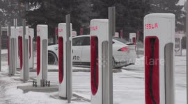 Tesla car battery charging station in cold weather and snow