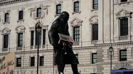 Students climb on Churchill statue during London climate protest