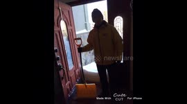 Husband Shovels snow while wife enjoys