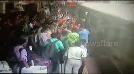 Police officers rush to save passengers who fell off moving train in Mumbai