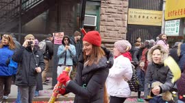 Chinatown NYC: Reveler shoots confetti before Chinese New Year Parade