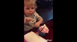Little girl trying strawberry ice cream first time mmm so good
