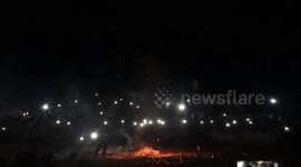 The men dance on the burning fire during the fire festival