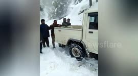 Car transporting patient to doctor stranded in snowy north Indian road