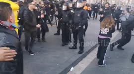 Catalan police hits protesters with batons during general strike