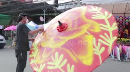 Graffiti artists spray paint contemporary designs on ancient Thai umbrellas