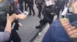 Catalan police hits protesters with batons during general strike