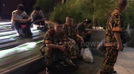 Three Chinese tourists in matching elephant print suits