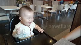 Baby laughing hysterically when his mom tickling him