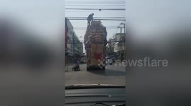 Passenger scales car with furniture stacked 20ft high to clear power lines