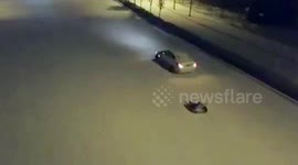 Girl riding tyre gets dragged along snowy road by her father in car in China's Henan