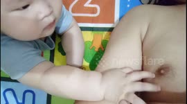 Funny Baby Keeps Playing his Dad's Nipple