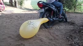 Hilarious moment a man tries to inflate a balloon using bike exhaust
