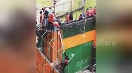 Football fans in Indonesia will scale the stadium walls to see their team