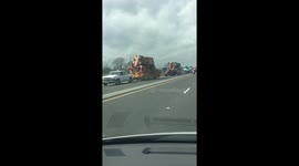 Trail of Mardi Gras floats seen on highway to New Orleans