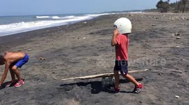 Quirky child’s play: beach seesaw spaceman  antics