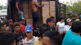Humanitarian aid rescued from burned trucks on the border between Colombia and Venezuela