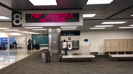 Woman using pay phone at Ft. Lauderdale Hollywood airport