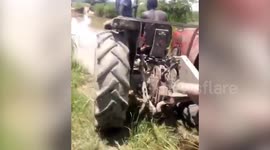 Brave farmers drive their tractor underwater